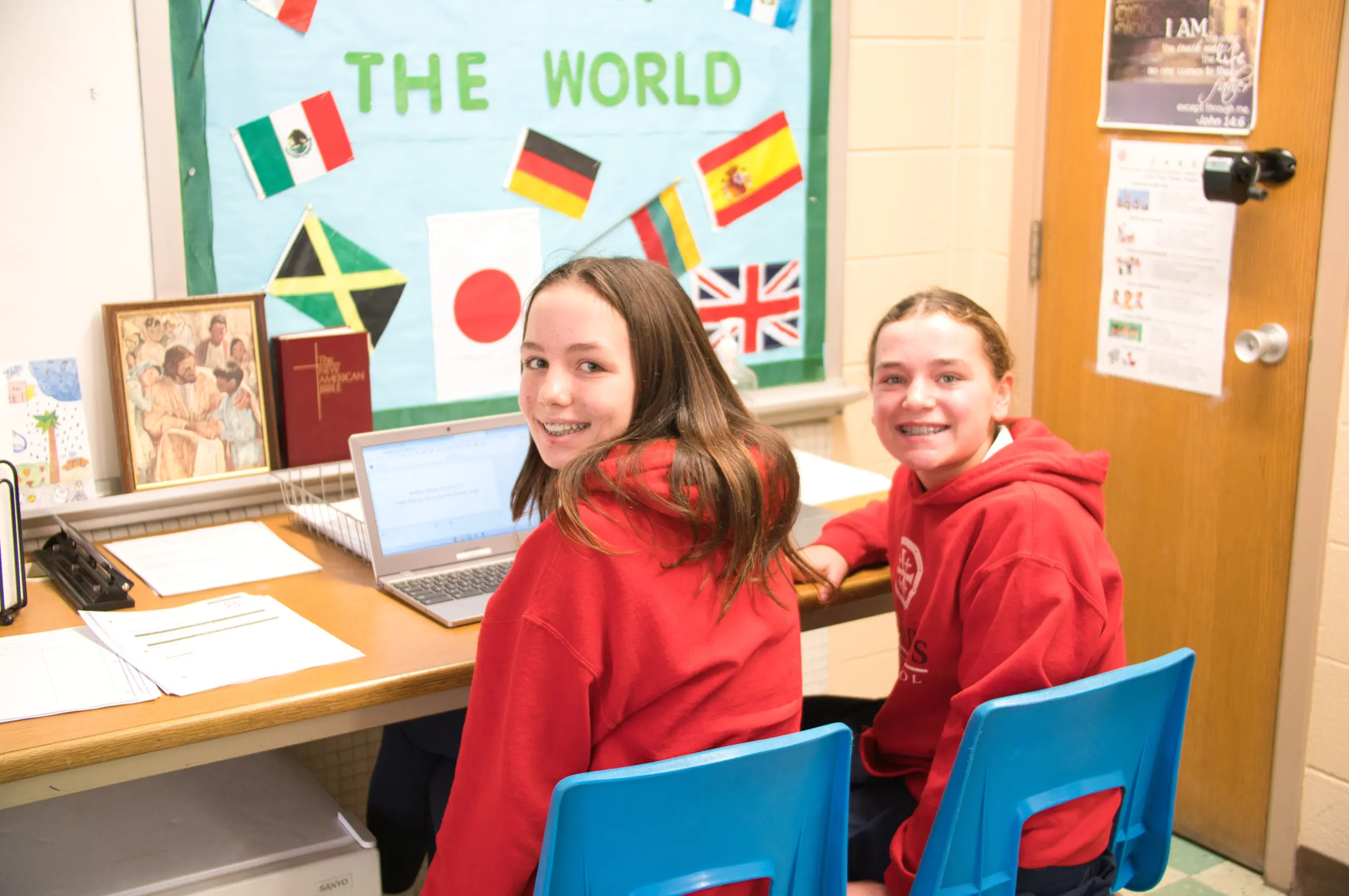 7th graders at their laptop at all saints catholic school